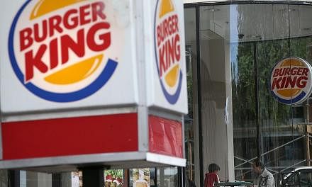 Customers dine at a Burger King restaurant in San Francisco, California on Aug 1, 2014.-- PHOTO: AFP