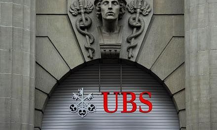 A logo of the Swiss banking giant UBS seen above its headquarters in downtown Zurich on Oct 15, 2011. -- PHOTO: AFP