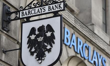 A Barclays sign hangs outside a branch of the bank in the City of London July 30, 2014.&nbsp;British bank Barclays agreed to pay US$20 million (S$25 million) to settle a class-action suit from investors who lost money in the Libor interest rate-riggi
