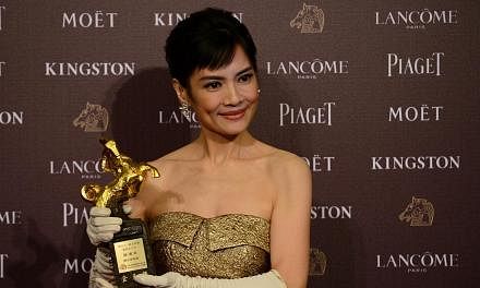 Taiwan actress Chen Shiang Chyi displays a trophy after winning the Best Leading Actress during the Golden Horse Film Awards in Taipei on Nov 22, 2014. -- PHOTO: AFP