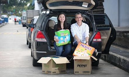Ms Desiree Yang, 20, and her father Roland Yang, 55, set up Saltsteps, a social supermarket that sells goods rejected by regular supermarkets – for example, goods with damaged packaging or incorrect labelling – to low-income families. -- ST PHOTO