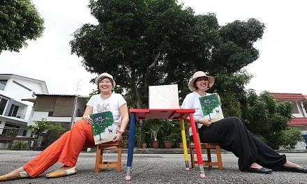 Local writers Lee Seow Ser (left) and Hidayah Amin, with the Braille and non-Braille versions of Ms Hidayah's The Mango Tree. The Braille version of the 32-page book for children has 10 pages, of which only one has illustrations. "If we had more mone