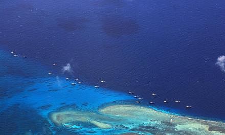 A Philippine military photo taken on July 17, 2012, showing Chinese fishing vessels anchored at Fiery Cross Reef on the disputed Spratly islands. Concerns about whether Malaysia would manage the South China Sea dispute impartially were allayed at the
