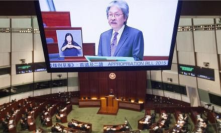 Hong Kong Financial Secretary John Tsang delivering the annual Hong Kong government Budget to the city's Legislative Council. -- PHOTO: EPA