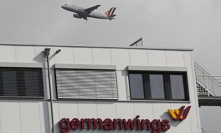 A Germanwings aircraft flies past the headquarters of Germanwings during take-off from Cologne-Bonn airport on March 27, 2015. The co-pilot suspected of deliberately crashing a Germanwings plane told his bosses he had suffered from severe depression,