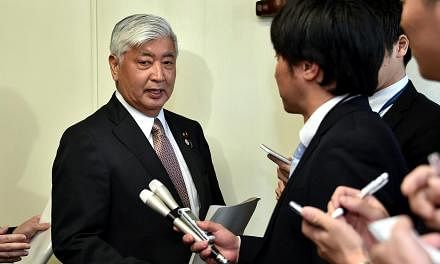Japanese defence minister, Gen Nakatani (left), speaking to the press in Tokyo on March 30, 2015. -- PHOTO: AFP&nbsp;