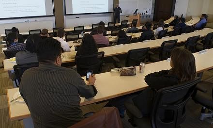 Students at a University of Pennsylvania's Wharton School lecture in San Francisco. Even if scholars agree on the importance of publishing in the popular media, the system plays against them. Publications in peer-reviewed journals continue to be the 