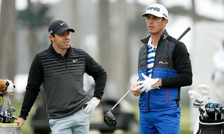 Rory McIlroy (left) of Northern Ireland talks to Billy Horschel (right) of the USA while they wait to tee off on the 16th hole during round three of the World Golf Championships Cadillac Match Play at TPC Harding Park in San Francisco, California on 