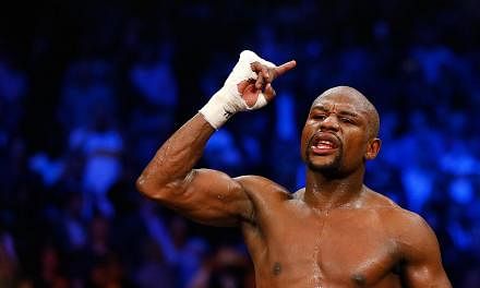 Floyd Mayweather Jr. reacts after the 12th round against Manny Pacquiao in their welterweight unification championship bout on May 2, 2015 at the MGM Grand Garden Arena in Las Vegas, Nevada.&nbsp;-- PHOTO: AFP