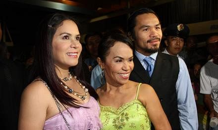 (From right) World welterweight boxing champion Manny Pacquiao is seen with his mother Dionisia Pacquiao and wife Jinkee Pacquiao at the KCC Mall on May 15, 2010 in General Santos, Philippines. -- PHOTO:&nbsp;GETTY IMAGES