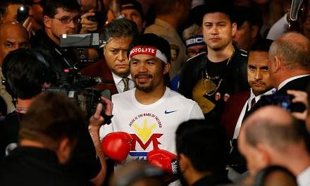 Manny Pacquiao walks to the ring with Jimmy Kimmel before his welterweight unification championship bout against Floyd Mayweather Jr. on May 2, 2015 at MGM Grand Garden Arena in Las Vegas, Nevada.&nbsp;-- PHOTO: AFP