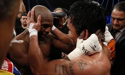 Floyd Mayweather Jr. hugs Manny Pacquiao after defeating Pacquiao in their welterweight unification bout on May 2, 2015 at the MGM Grand Garden Arena in Las Vegas, Nevada.&nbsp;-- PHOTO: AFP