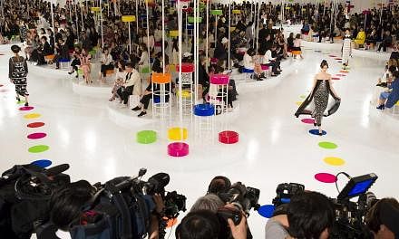 Models present creations of the Chanel Cruise Collection 2015/16 at the Dongdaemun Design Plaza in Seoul on Monday. French fashion house Chanel looked to traditional South Korean dress for its cruise collection, unveiling a colourful inter-seasonal l
