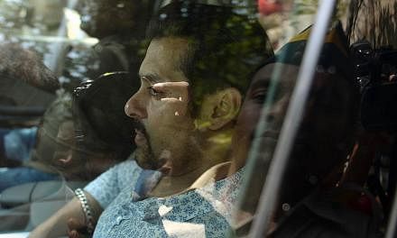 In this file photograph taken on May 6, 2014, Indian Bollywood film actor Salman Khan leaves in a car after appearing at the sessions court in Mumbai. Bollywood star Salman Khan, known for his bulging biceps and off-camera temper tantrums, faces jail