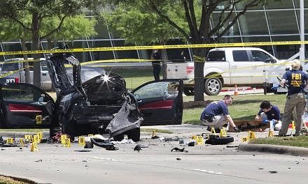 Local police and FBI investigators collect evidence where two gunmen, who opened fire on Sunday outside an exhibit of caricatures of the Prophet Muhammad, were shot dead in Garland, Texas on May 4, 2015. -- PHOTO: REUTERS