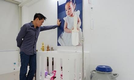 Dr Sahatorn Naovaratpong, a businessman, at the cot where his daughter, Matheryn, used to sleep when she was battling brain cancer, until her death in January 2015. -- ST PHOTO: TAN HUI YEE