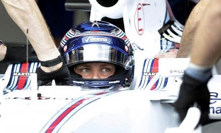 Williams Martini Racing's Finnish driver Valtteri Bottas sits in the pits during qualifying for the Formula One Australian Grand Prix in Melbourne on March 14, 2015. -- PHOTO: AFP&nbsp;