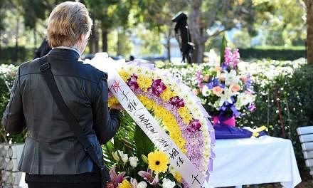 A mourner placing a floral wreath at the funeral service of Andrew Chan in Sydney, Australia, on May 8, 2015. -- PHOTO: EPA