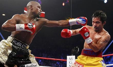 Floyd Mayweather Jr (left) and Manny Pacquiao during the fifth round of their fight in Las Vegas on May 2, 2015. Two days after saying he would be open to a re-match with Pacquiao, Mayweather reversed course on Thursday, describing the Filipino as "a