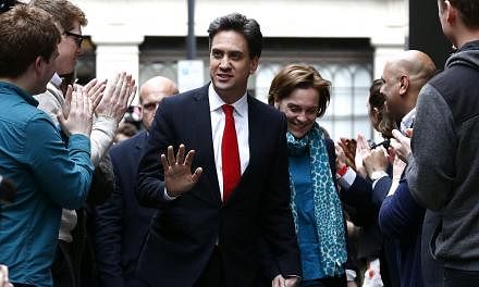 Labour Party leader Ed Miliband and his wife Justine Thornton arriving at Labour Party headquarters in London on May 8, 2015. -- PHOTO: AFP &nbsp;