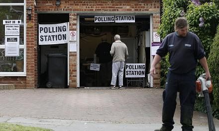 A man arrives to vote at a polling station set up in the garage of a house in Croydon on Tuesday, as Britain holds a general election. -- PHOTO:&nbsp;AFP