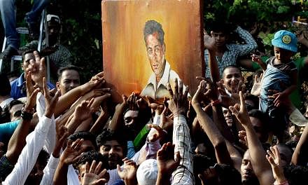 Fans celebrating outside Salman Khan's house in Galaxy Apartment after the superstar got bail in his hit-and-run case in Mumbai on Friday. Khan's five-year prison sentence was suspended pending an appeal. -- PHOTO: AGENCE FRANCE-PRESSE
