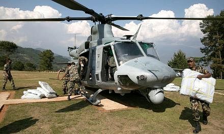 Nepali and United States troops were scouring the area worst-hit by a second large earthquake for a missing US Marine helicopter on Wednesday. -- PHOTO: AFP