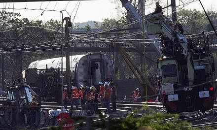 Track workers and officials working at the site of a derailed Amtrak train in Philadelphia, Pennsylvania, on May 14, 2015. -- PHOTO: REUTERS