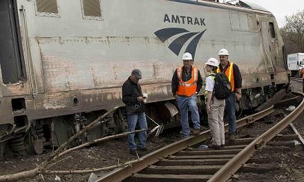 National Transportation Safety Board officials on the scene of the Amtrak derailment in Philadelphia on May 13, 2015. The train and a separate commuter train in the vicinity may have been hit by projectiles of some kind shortly before the wreck, a US