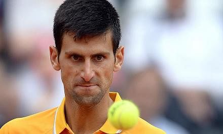 Novak Djokovic of Serbia eyes the ball during the semi final match against David Ferrer of Spain at the Italian Open on May 16, 2015, in Rome. -- PHOTO: AFP