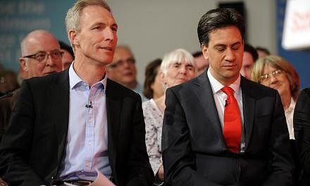 Scottish Labour Party leader Jim Murphy (left) sits with opposition&nbsp;Labour Party leader Ed Miliband (right)&nbsp;at a Labour Party general election campaign rally in Glasgow, Scotland, on May 1, 2015. -- PHOTO: AFP