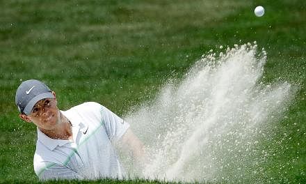 Rory McIlroy of Northern Ireland takes his shot out of the bunker on the fifth hole during round three at the Wells Fargo Championship at Quail Hollow Club on May 16, 2015 in Charlotte, North Carolina. -- PHOTO: AFP