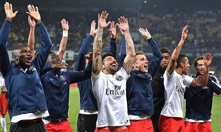 Paris Saint-Germain's players celebrate their 2-1 win at Montpellier on Saturday.&nbsp;PSG won their third consecutive French Championship title by winning the match. -- PHOTO: AFP&nbsp;