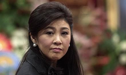 Thailand's first female prime minister Yingluck Shinawatra (above) is expected to appear in court today for the start of a negligence trial which could see her jailed for a decade. -- PHOTO: AFP