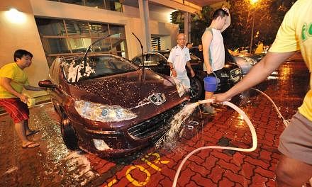 Students taking part in a fund-raising car wash as part of the Victoria Challenge in 2011. -- PHOTO: ST FILE
