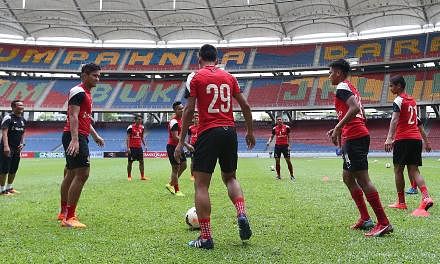 LionsXII coach Fandi Ahmad (left), who has a history of success on Malaysian soil, directing the LionsXII during a training session at Bukit Jalil Stadium yesterday. In 1980, 18-year-old Fandi scored the winner against Selangor and 14 years later, he