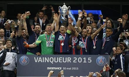 Paris St Germain's players celebrate with the trophy after winning the Coupe de France final match between Paris Saint Germain (PSG) and AJ Auxerre at the Stade de France in Saint-Denis outside Paris, France, on May 30, 2015. -- PHOTO: EPA&nbsp;