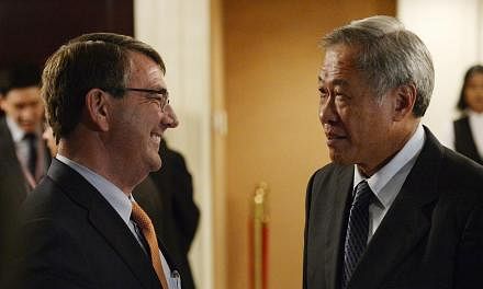 Singapore Defence Minister Ng Eng Hen (right) with US Secretary of Defence Ashton Carter during the ministerial luncheon yesterday. Dr Carter spoke at the Shangri-La Dialogue as Pentagon chief for the first time.