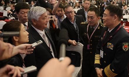 Japanese Defence Minister Gen Nakatani (left) speaking with Admiral Sun Jianguo, Chinese deputy chief, General Staff Department, People's Liberation Army, during the IISS Shangri-La Dialogue yesterday.