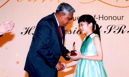 Abigail Sin at age four with her twin Josiah, younger brother David and father Sin Lye Kuen. Abigail Sin at age 11, receiving the HSBC Youth Excellence Award from then President S R Nathan. Abigail Sin at age eight in Methodist Girls' School.