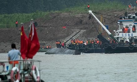 &nbsp;Rescue workers are seen on the hull of capsized passenger ship Dongfangzhixing or "Eastern Star" in the Yangtze river at Jianli in China's Hubei province on June 3, 2015. -- PHOTO: AFP