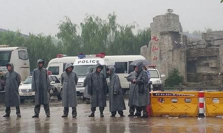 A police cordon outside the Rongcheng crematorium in Jianli county, Hubei province. Members of the media were barred from entering the premises. -- ST PHOTO: KOR KIAN BENG