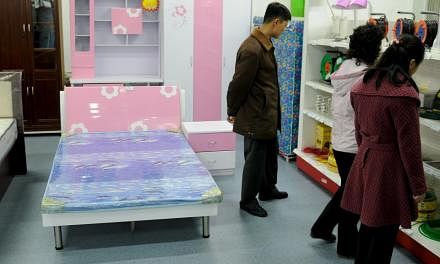 North Korean people shopping at Kwangbok department store in central Pyongyang, North Korea, in this March 16, 2014 handout photograph. -- PHOTO: REUTERS