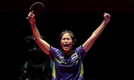 Thailand's Suthasini Sawettabut reacts after beating Malaysia's Ng Sock Khim 4-3 in the SEA Games table tennis women's singles final at the Singapore Indoor Stadium on Thursday night. -- PHOTO: REUTERS&nbsp;