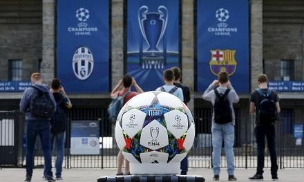 The official Adidas match ball being used for the June 6, 2015, Champions League final between Barcelona and Juventus in Berlin is pictured in front of the&nbsp; Olympiastadion on June 2. -- PHOTO: REUTERS