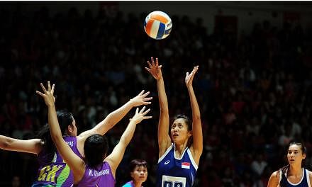 Singapore's Charmaine Soh shoots against Thailand in their netball semi-final on June 6, 2015. Singapore won 59-29 to set up a final clash with Malaysia. -- PHOTO: AFP&nbsp;