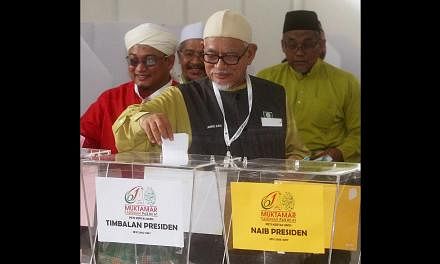 Parti Islam SeMalaysia president Abdul Hadi Awang casting his vote at the party elections last week. The pro-ulama group outvoted the professionals and won almost all the seats in the main executive committee while expanding their dominance to the yo