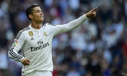 Real Madrid's Portuguese forward Cristiano Ronaldo celebrates after scoring against Getafe at the Santiago Bernabeu stadium in Madrid on May 23, 2015. Ronaldo remains Europe's and the world's most marketable footballer, according to a study released 