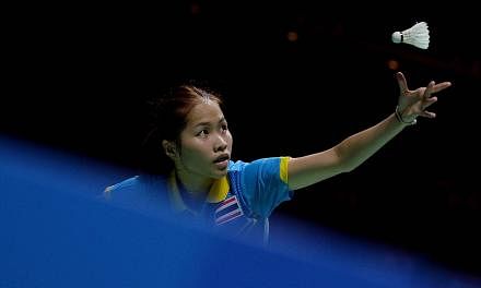 Ratchanok Intanon of Thailand serving against Liang Xiaoyu of Singapore in their women's team badminton semi-final at the Singapore Indoor Stadium on June 11, 2015.&nbsp;-- PHOTO: AFP&nbsp;
