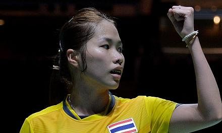 Ratchanok Intanon of Thailand reacts after winning a point against Lim Yin Fun of Malaysia in their women's team badminton final match during the 28th SEA Games in Singapore on June 12, 2015. -- PHOTO: AFP&nbsp;